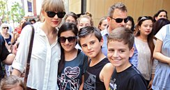 Taylor Swift posing with fans in Australia