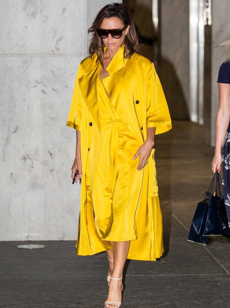 Victoria Beckham ditches the black and opts for yellow as she sports a ...